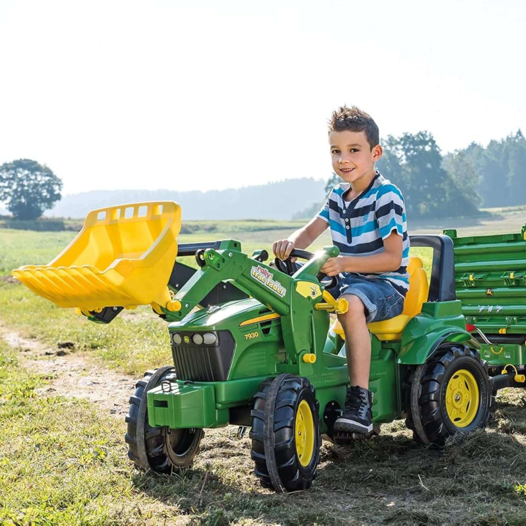 Boy riding John Deere 7930 Pedal Tractor with Frontloader