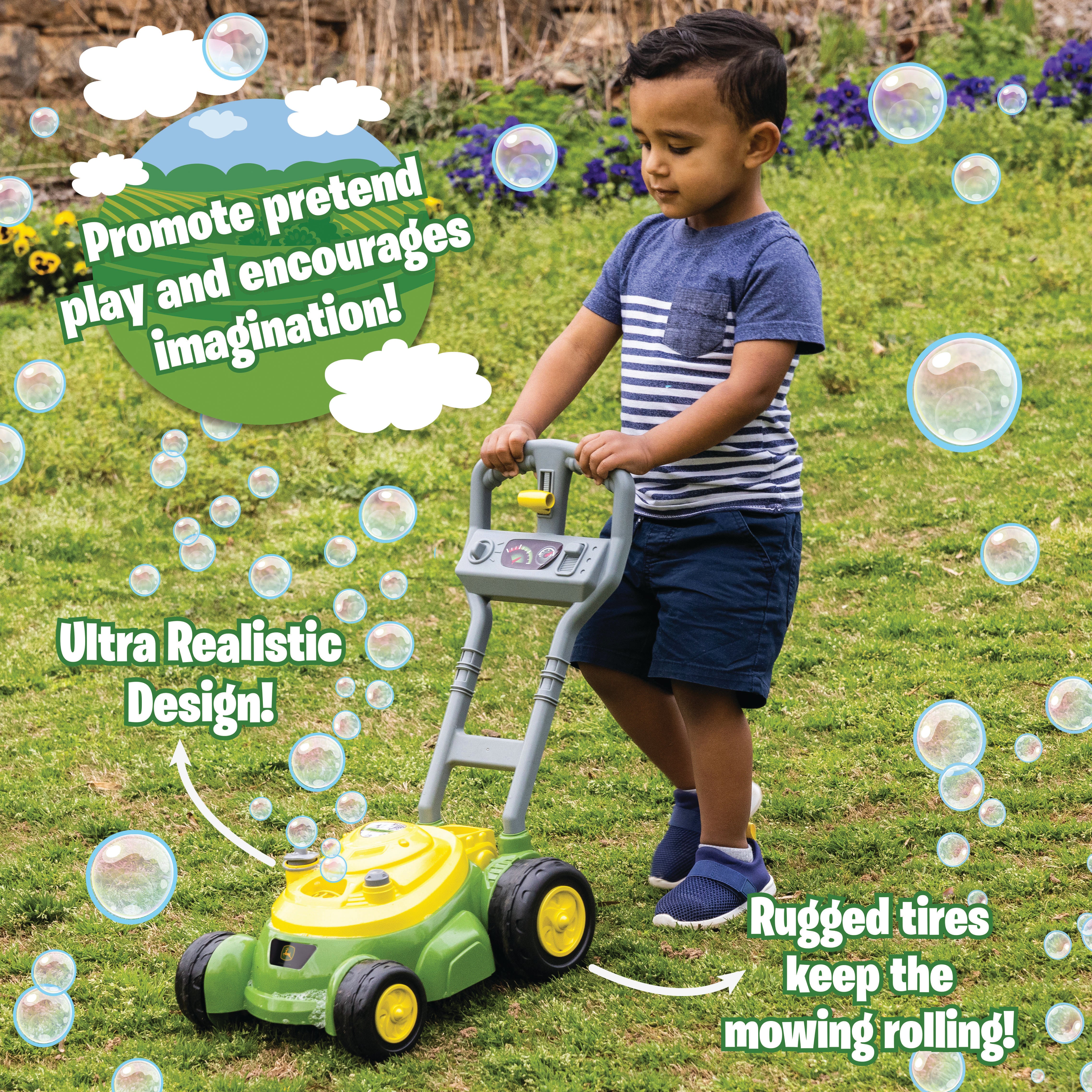 Child playing with John Deere Bubble Mower toy outdoors
